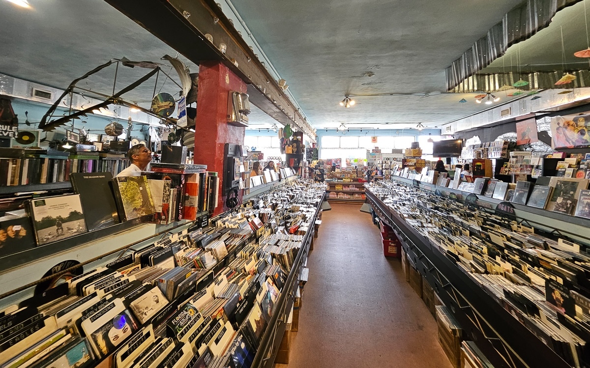 inside record shop with aisles of records