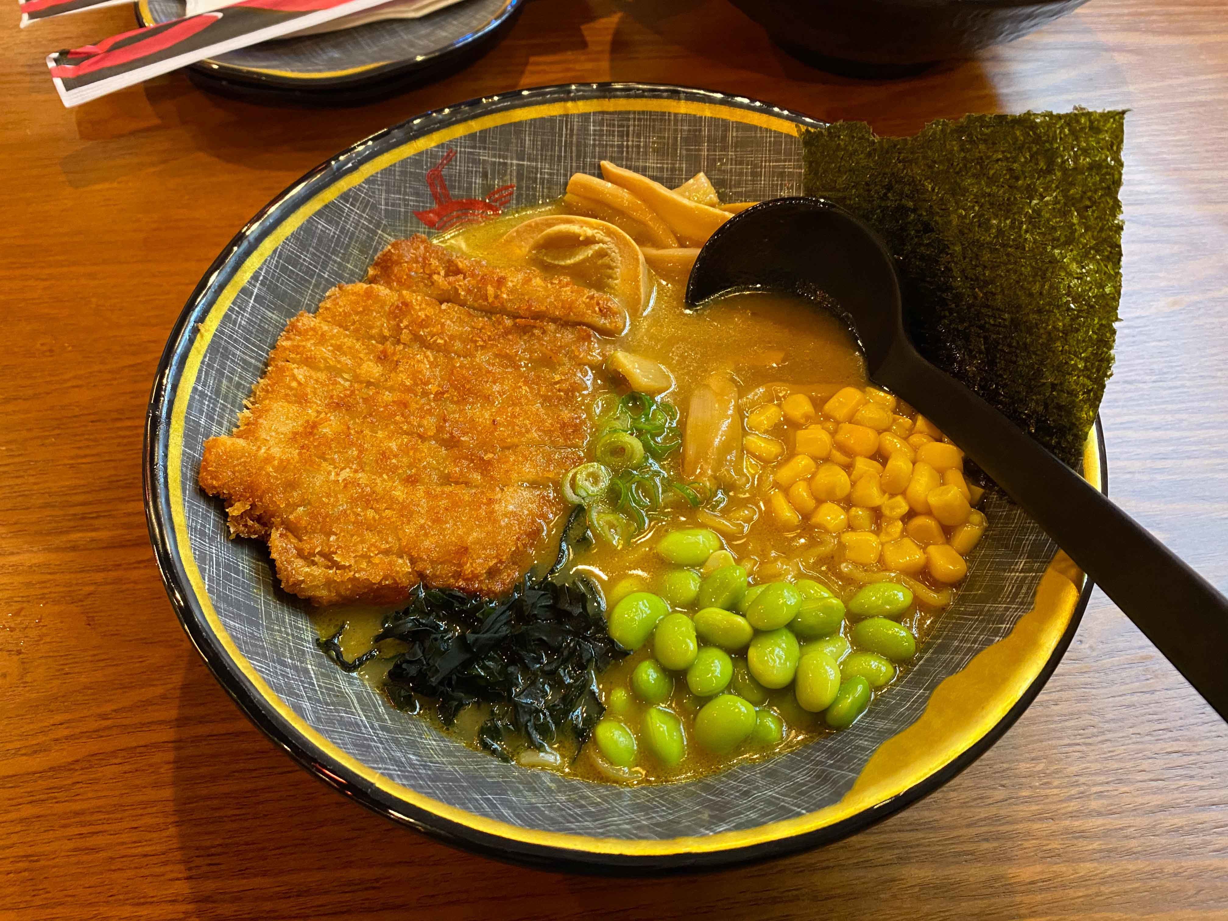 bowl of ramen with chicken and other toppings